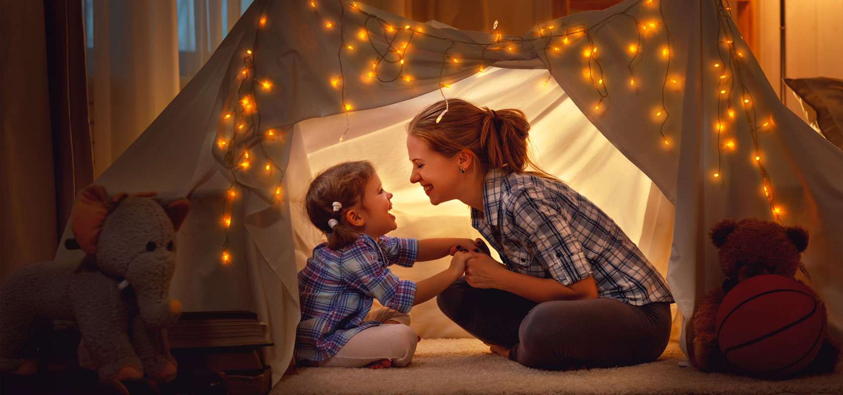 Mom building a fort with her daughter, feeling safe with their new security system