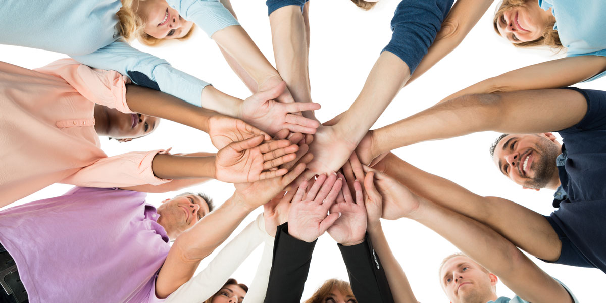 People huddled in a circle with their hands together celebrating largest home security company